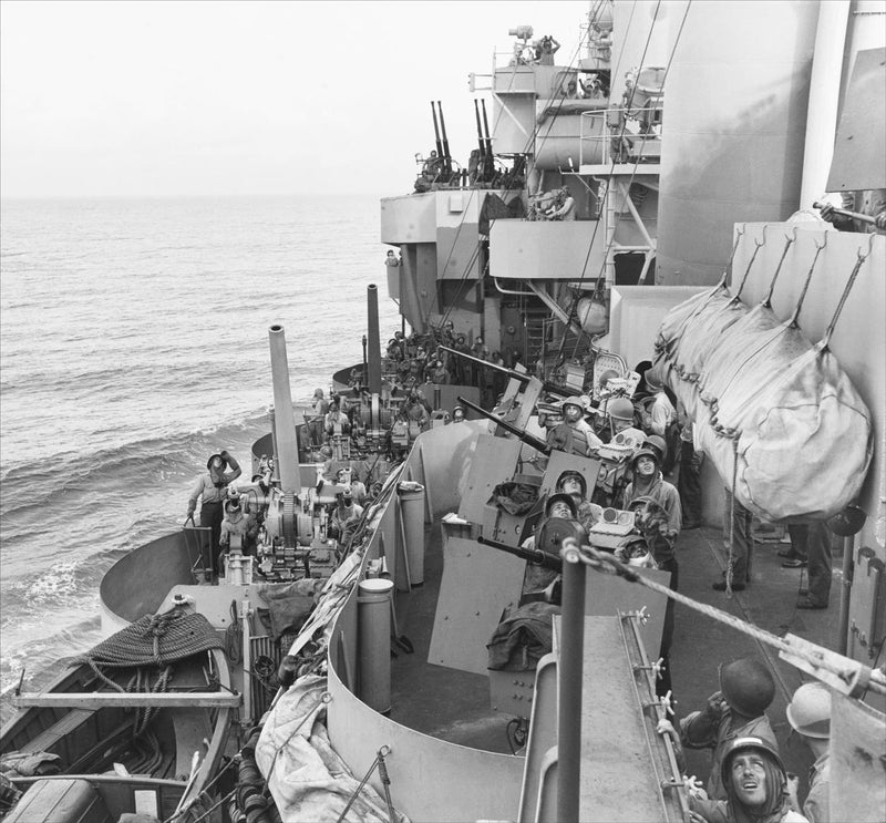 Crewmen Aboard the USS Phoenix Anxiously Glance at the Sky, in a Time of an Intense Kamikaze Attacks