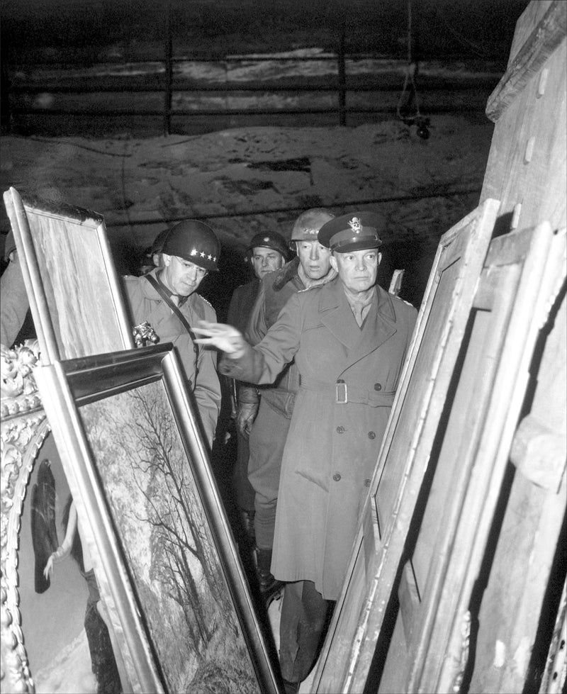 General Dwight D. Eisenhower, Supreme Allied Commander, accompanied by Gen. Omar N. Bradley, and Lt. Gen. George S. Patton, Jr., inspects art treasures stolen by Germans and hidden in salt mine in Germany